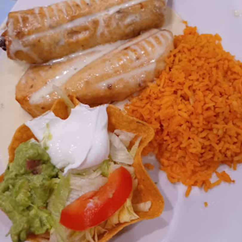 Padrino's Mexican dish with two enchiladas, a side of orange rice, and a taco salad.
